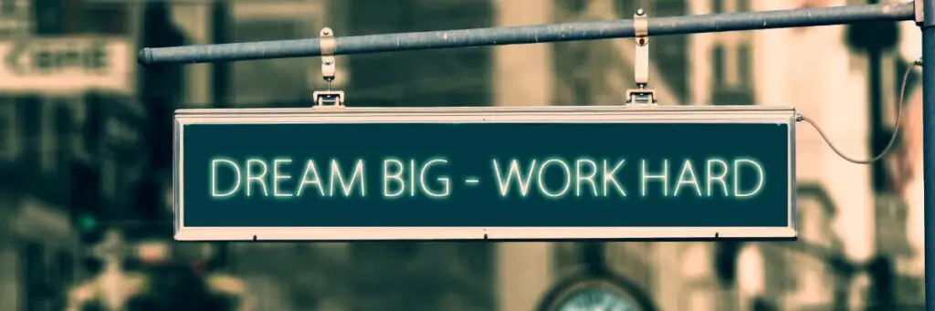 outdoor street sign with the words "dream big work hard"